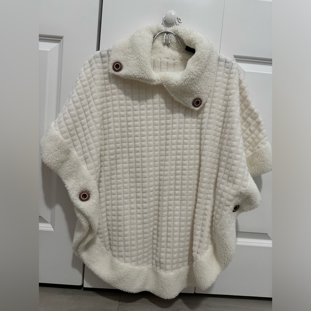 White poncho sweater with cute button detail!